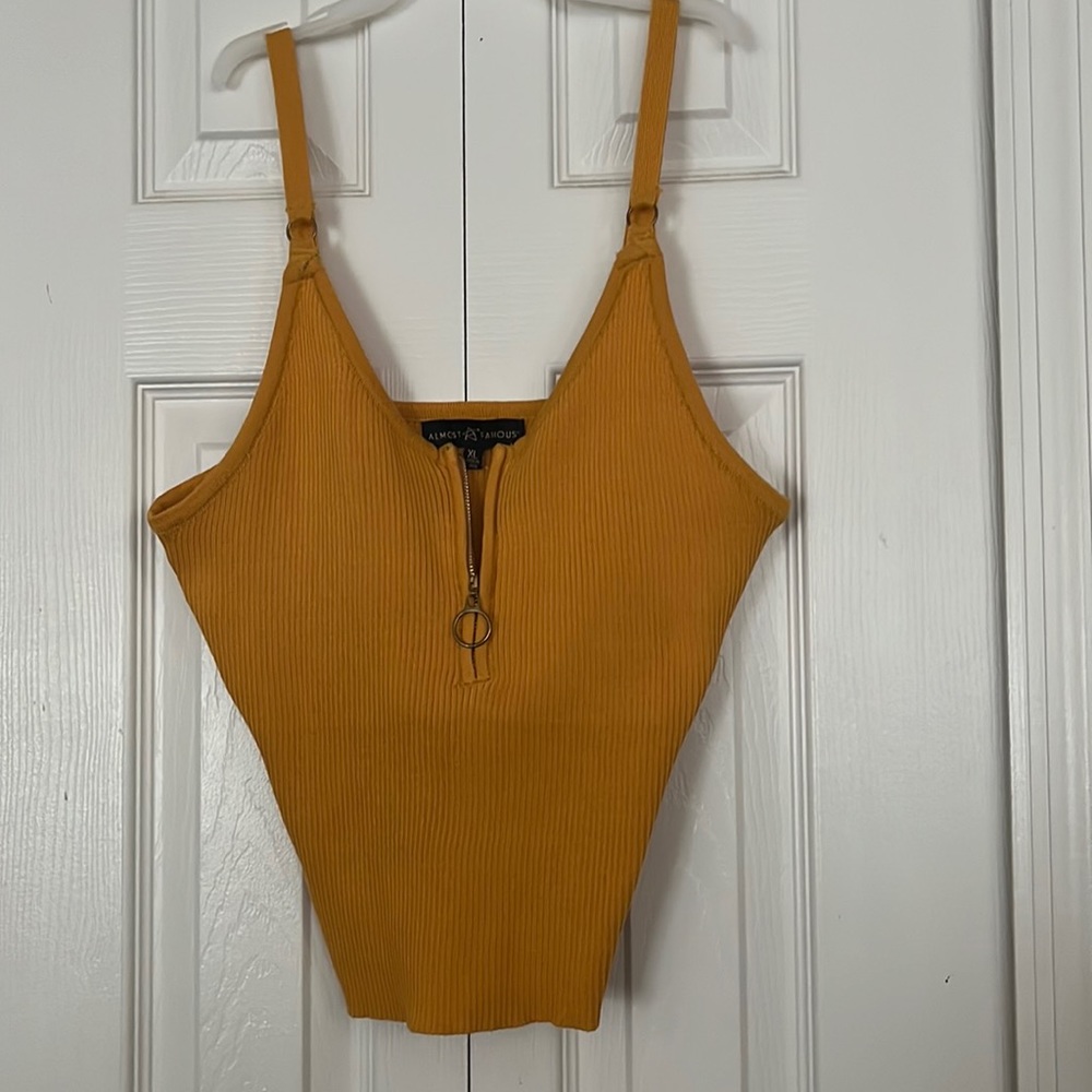 A mustard type tank top, very softly worn like new.